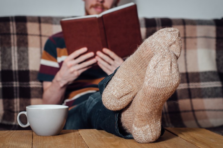 Man Reading a Book Wearing Socks